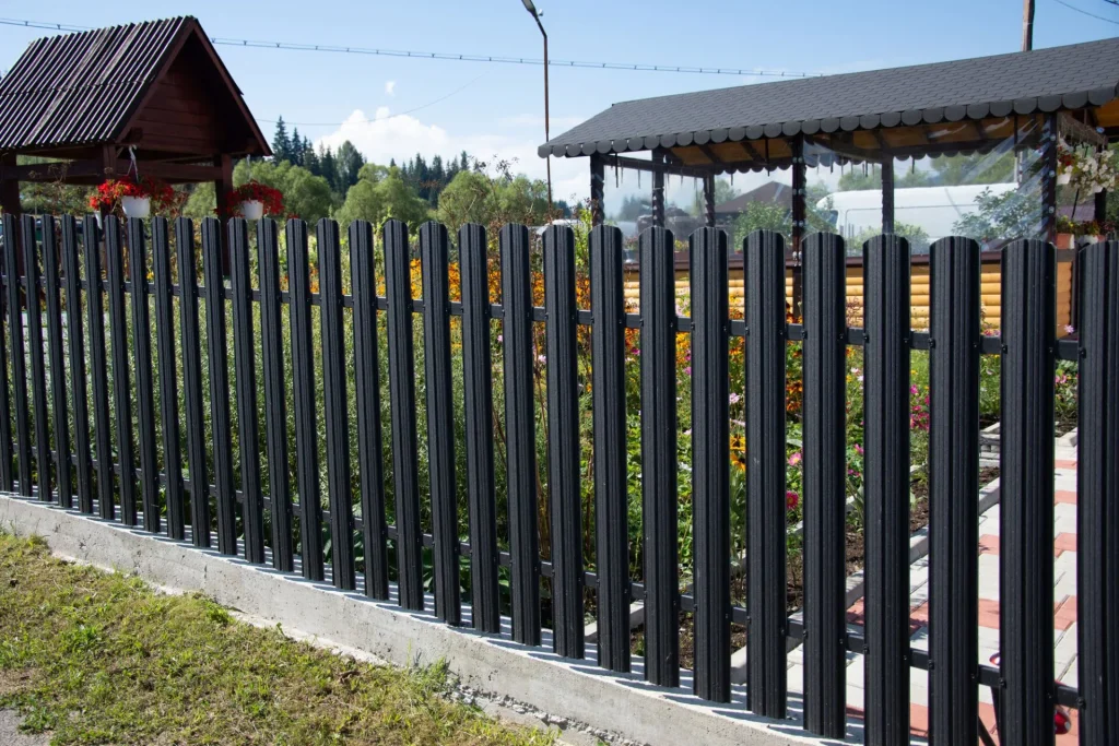 black aluminum fencing with a building in the background